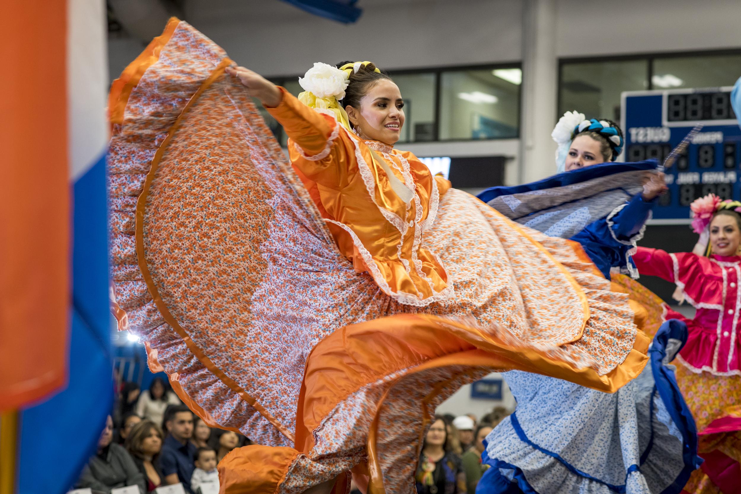 Latin dancers spinning in their flowy dresses